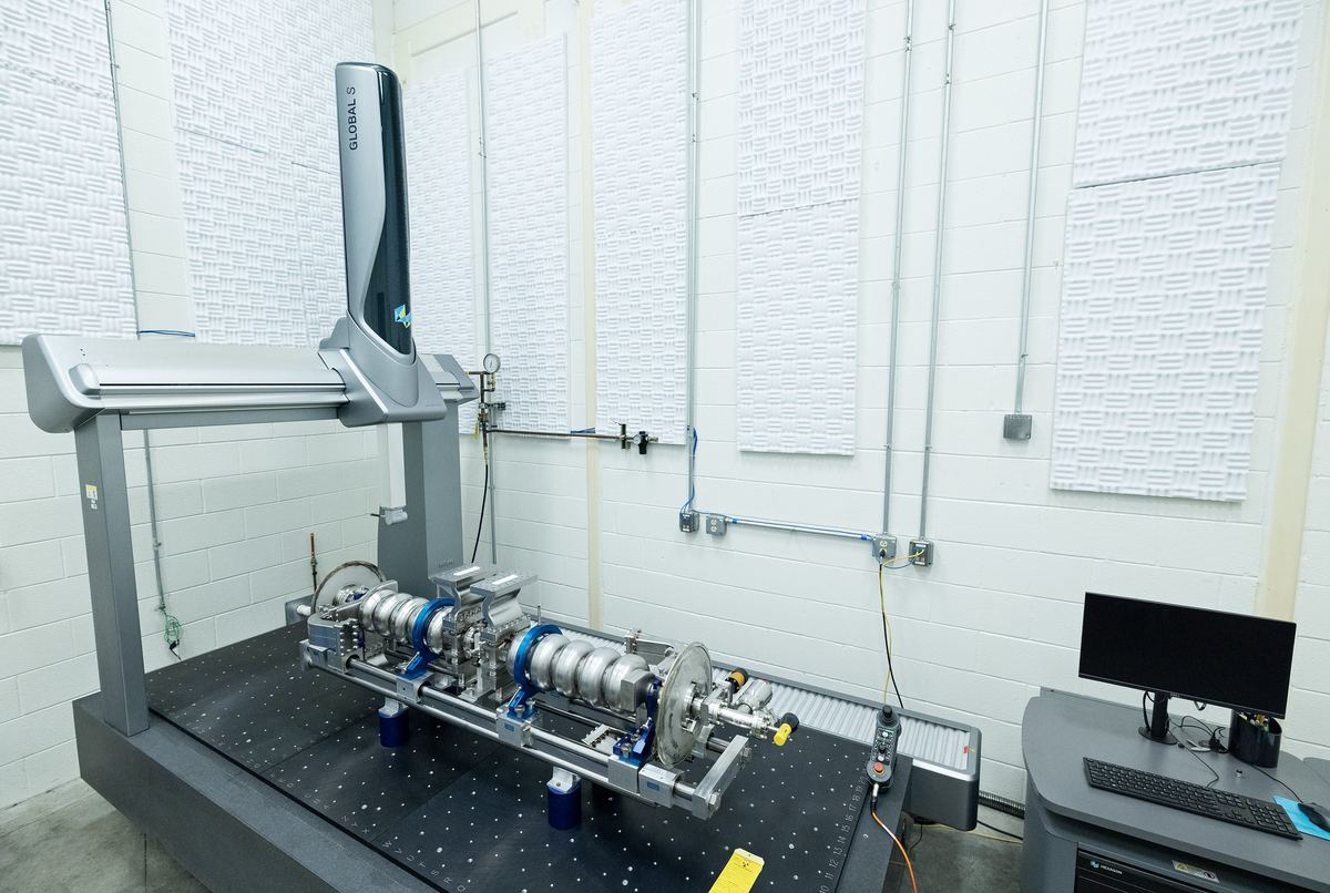 Bridge CMM measuring a precision assembly in a climate-controlled quality lab