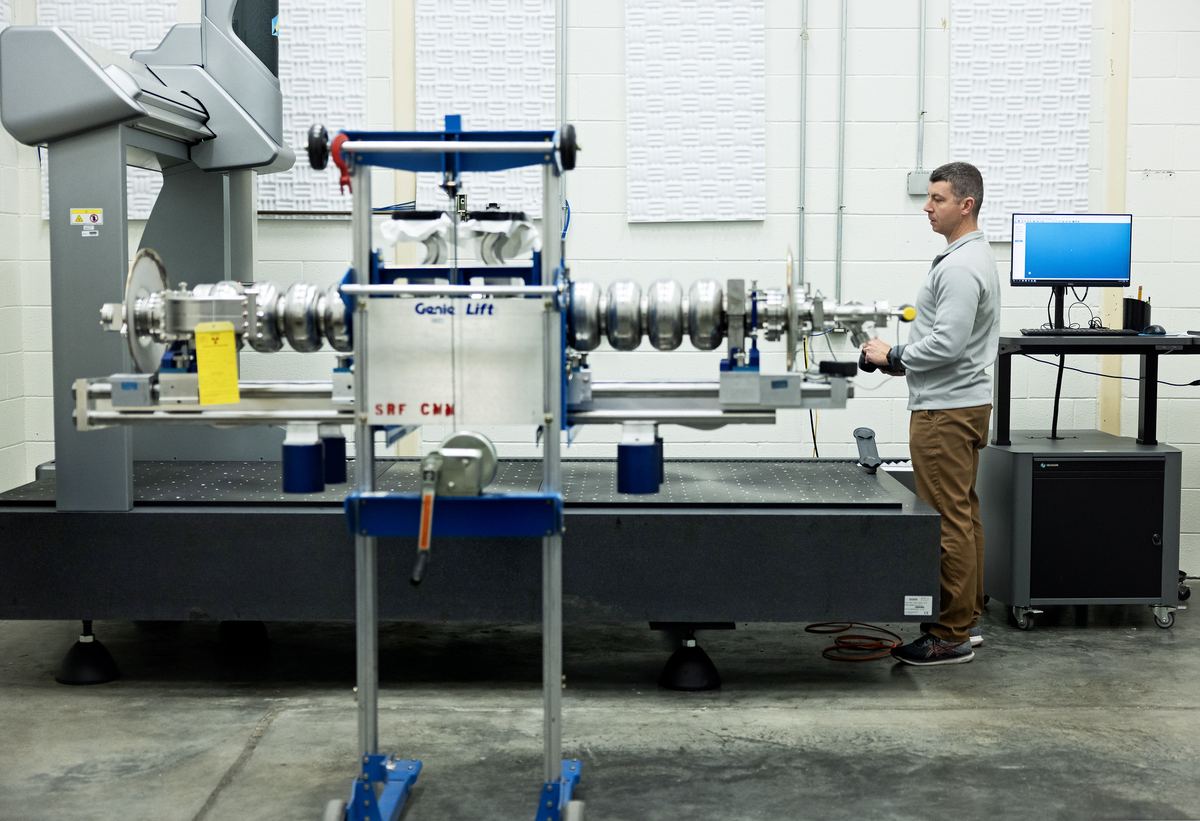 CMM programmer at the controls of a large coordinate measuring machine