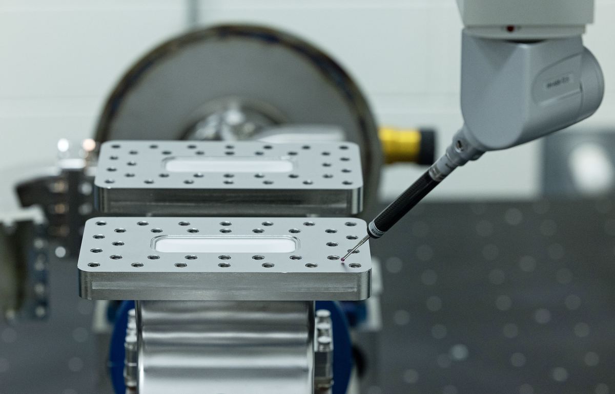 CMM probe measuring a machined fixture plate