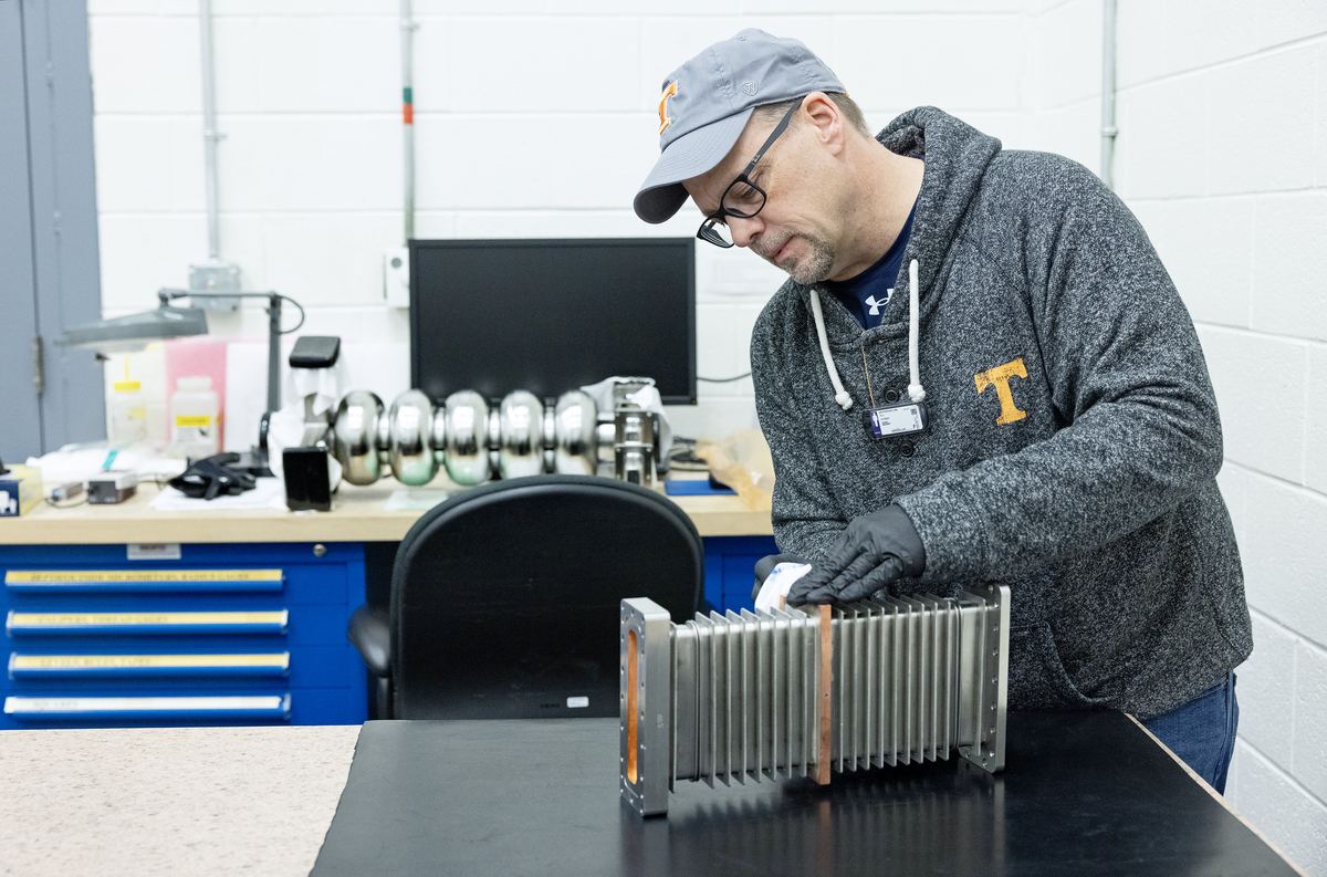 Quality inspector checking a machined component at an inspection bench